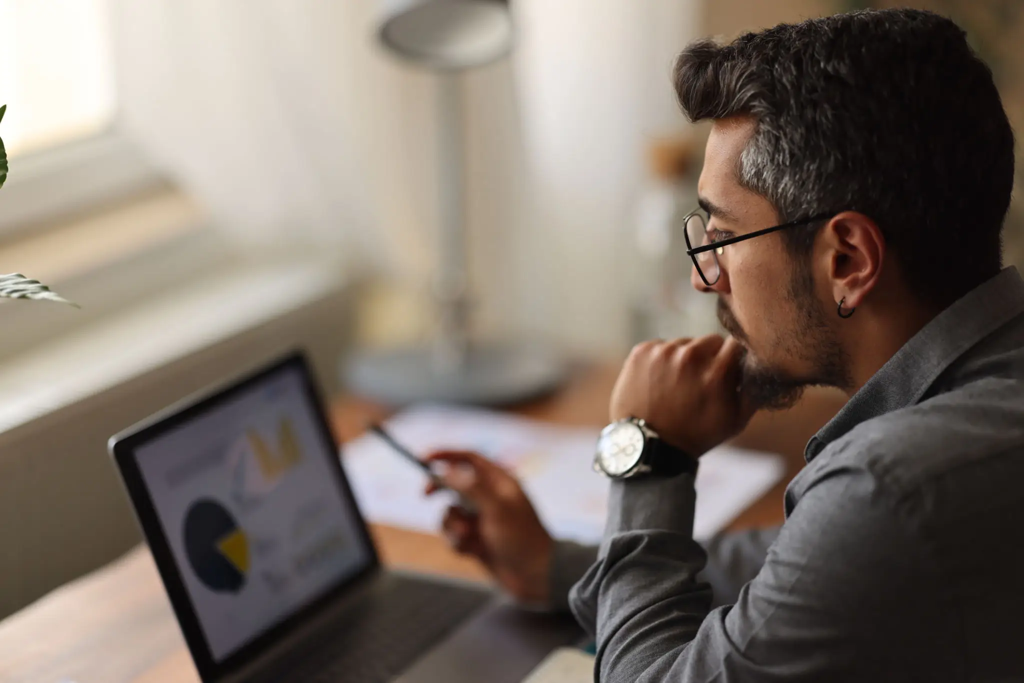 Man analyzing data on laptop