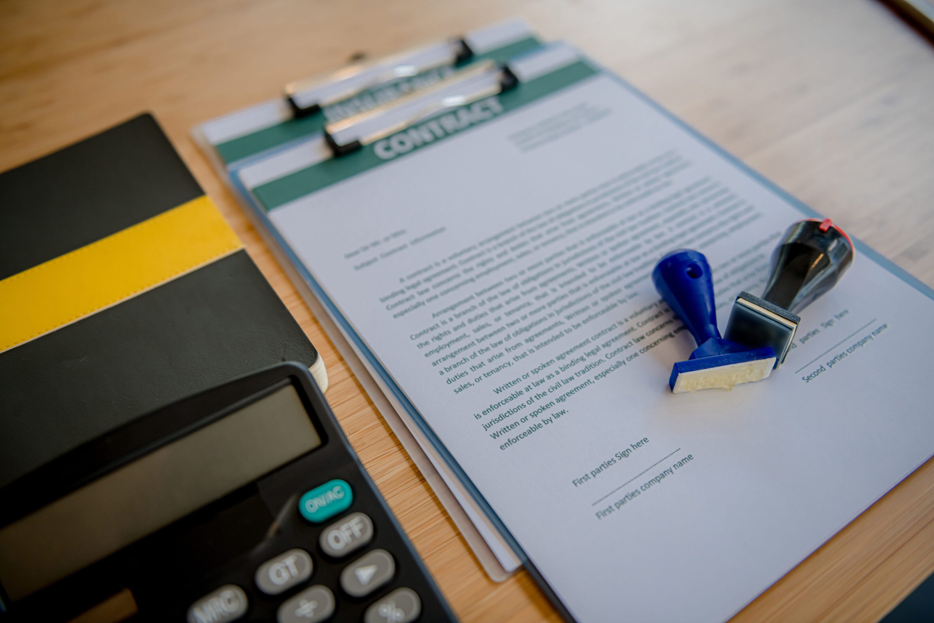 Mortgage contract for sale of real estate property with a pen and house keys